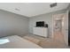 Large primary bedroom with a dresser, television, and carpet flooring at 5269 Silver Branch Ave, Las Vegas, NV 89118