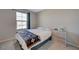 Cozy bedroom with natural light from the window and a comfortable bed with a blue throw at 5269 Silver Branch Ave, Las Vegas, NV 89118