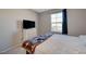 A bedroom is bathed in natural light from the window and features a comfortable bed at 5269 Silver Branch Ave, Las Vegas, NV 89118