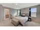 Comfortable primary bedroom with a large bed, natural light, and attached bathroom at 5269 Silver Branch Ave, Las Vegas, NV 89118