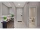 Clean entryway with white tile flooring, a dark wood console table, and access to a half bathroom at 5269 Silver Branch Ave, Las Vegas, NV 89118