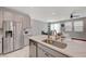 This kitchen features stainless steel appliances, marble countertops, and an open-concept design at 5269 Silver Branch Ave, Las Vegas, NV 89118