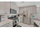 Contemporary kitchen with stainless steel appliances, light gray cabinets, and bright marble countertops at 5269 Silver Branch Ave, Las Vegas, NV 89118