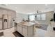 Modern kitchen with an island, stainless steel appliances, and a seamless transition to the living area, perfect for entertaining at 5269 Silver Branch Ave, Las Vegas, NV 89118