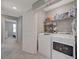 Laundry room with full-size washer and dryer and built-in shelving for storage at 5269 Silver Branch Ave, Las Vegas, NV 89118