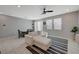 Open-concept living room with neutral tones, a comfortable sofa, and plenty of natural light at 5269 Silver Branch Ave, Las Vegas, NV 89118