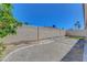 View of the backyard with paved area, fountain, and desert landscaping, all enclosed by a tall wall at 534 Rancho Del Mar Way, North Las Vegas, NV 89031