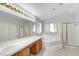 A bright bathroom with dual sinks, a soaking tub, and a glass-enclosed shower, perfect for unwinding at 534 Rancho Del Mar Way, North Las Vegas, NV 89031
