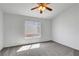Bedroom with gray carpet, ceiling fan, and bright window at 534 Rancho Del Mar Way, North Las Vegas, NV 89031