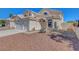 Two-story home featuring a two-car garage, desert landscaping and red tile roof at 534 Rancho Del Mar Way, North Las Vegas, NV 89031