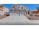 Two-story home featuring a two-car garage, desert landscaping and red tile roof at 534 Rancho Del Mar Way, North Las Vegas, NV 89031