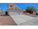 Two-story home featuring a two-car garage, desert landscaping and red tile roof at 534 Rancho Del Mar Way, North Las Vegas, NV 89031