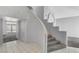 Bright foyer featuring tiled entry, modern carpet, and curved staircase at 534 Rancho Del Mar Way, North Las Vegas, NV 89031