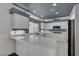 Bright kitchen boasts white cabinetry, stainless appliances, and plenty of natural light at 534 Rancho Del Mar Way, North Las Vegas, NV 89031