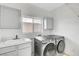 Laundry room with washer, dryer, and storage cabinets at 534 Rancho Del Mar Way, North Las Vegas, NV 89031