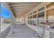 View of the covered patio with ceiling fans and a stainless steel grill in the backyard at 534 Rancho Del Mar Way, North Las Vegas, NV 89031