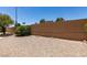 Backyard featuring low-maintenance desert landscaping and privacy wall at 5405 Lucky Clover St, Las Vegas, NV 89149