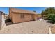 Side view of the house, with a gravel backyard, small shed, and covered patio at 5405 Lucky Clover St, Las Vegas, NV 89149