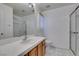 Bright bathroom featuring a white vanity, sink, and a glass enclosed shower at 5405 Lucky Clover St, Las Vegas, NV 89149