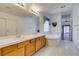Bright bathroom featuring dual sinks, a soaking tub, and access to a private patio at 5405 Lucky Clover St, Las Vegas, NV 89149