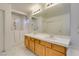 Bright bathroom featuring dual sinks, and walk-in tub and shower at 5405 Lucky Clover St, Las Vegas, NV 89149