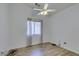 Neutral bedroom with wood-look floors, ceiling fan, and window at 5405 Lucky Clover St, Las Vegas, NV 89149