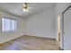 Bright, minimalist bedroom with a ceiling fan, wood floors and a closet at 5405 Lucky Clover St, Las Vegas, NV 89149