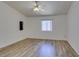 Minimalist bedroom features wood floors, and large window for natural light at 5405 Lucky Clover St, Las Vegas, NV 89149