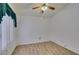 Cozy bedroom features wood-look floors, a ceiling fan, and natural light from the window at 5405 Lucky Clover St, Las Vegas, NV 89149