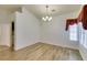 Dining room with hardwood flooring, modern chandelier, and natural light at 5405 Lucky Clover St, Las Vegas, NV 89149