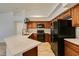 Updated kitchen features granite countertops and black appliances with wood cabinets at 5405 Lucky Clover St, Las Vegas, NV 89149