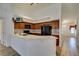 Kitchen with stainless appliances and wood cabinets leads into a bright living area at 5405 Lucky Clover St, Las Vegas, NV 89149