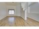 Open-concept living room featuring hardwood floors, modern lighting fixtures, and bright, airy feel at 5405 Lucky Clover St, Las Vegas, NV 89149
