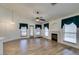 Bright living room features wood floors, a ceiling fan, and a cozy fireplace at 5405 Lucky Clover St, Las Vegas, NV 89149