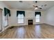 Living room featuring a ceiling fan, modern wood floors, and natural light at 5405 Lucky Clover St, Las Vegas, NV 89149