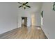 Spacious living room with wood-look floors, a fan, and multiple doorways at 5405 Lucky Clover St, Las Vegas, NV 89149