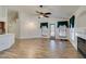 Open living room with wood floors, ceiling fan, fireplace, and natural light at 5405 Lucky Clover St, Las Vegas, NV 89149