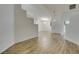 Spacious living room featuring modern wood floors, white walls, and staircase at 5405 Lucky Clover St, Las Vegas, NV 89149