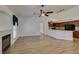 Open living area showcasing fireplace, modern wood floors, and kitchen area at 5405 Lucky Clover St, Las Vegas, NV 89149