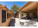 Covered patio with stone flooring and backyard access near gazebo structure at 5405 Lucky Clover St, Las Vegas, NV 89149