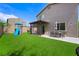 This backyard offers a seating area, artificial grass and play area at 5631 Hill Cliff Ct, North Las Vegas, NV 89031