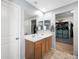 Bathroom with double sinks, large mirror, and walk-in closet at 5631 Hill Cliff Ct, North Las Vegas, NV 89031