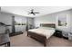 Bedroom with a dark wood bed frame and ceiling fan at 5631 Hill Cliff Ct, North Las Vegas, NV 89031