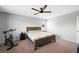 Bedroom with a dark wood bed frame and ceiling fan at 5631 Hill Cliff Ct, North Las Vegas, NV 89031