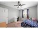 Bright bedroom with ceiling fan, desk, and window providing natural light for a cozy and functional space at 5631 Hill Cliff Ct, North Las Vegas, NV 89031