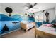 Shared bedroom with two twin beds and unique silhouette wall decor at 5631 Hill Cliff Ct, North Las Vegas, NV 89031