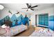 Vibrant shared bedroom featuring unique wall decor, ceiling fan, and comfortable twin beds for a playful space at 5631 Hill Cliff Ct, North Las Vegas, NV 89031