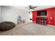 Carpeted bonus room includes a dollhouse, beanbag, and a red accent wall with a TV at 5631 Hill Cliff Ct, North Las Vegas, NV 89031