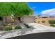 Charming two-story home with desert landscaping, green tree and covered front porch at 5631 Hill Cliff Ct, North Las Vegas, NV 89031