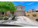 Charming two-story home with desert landscaping, green tree and covered front porch at 5631 Hill Cliff Ct, North Las Vegas, NV 89031